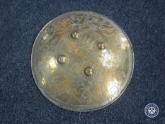 A brass Indian shield decorated with fauna,