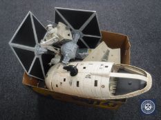 A box containing 1980's Star Wars ships