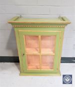 A painted and gilt glazed display cabinet