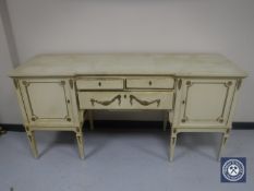 A continental cream and gilt sideboard