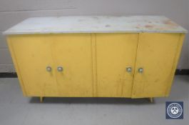 A mid 20th century four door kitchen cabinet