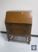 An early 20th century oak bureau fitted two drawers