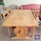 A blonde oak refectory extending table with two leaves and four matching chairs