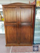 A stained pine double door wardrobe