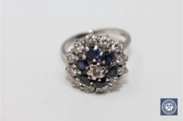 An 18ct white gold diamond and sapphire cluster ring, approximately 0.9ct.