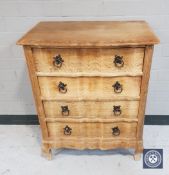A continental oak serpentine front chest of three drawers