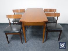 A 1970's teak drop leaf kitchen table together with four chairs