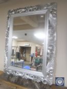 An ornate silvered overmantel mirror