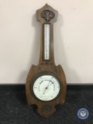 A carved oak barometer