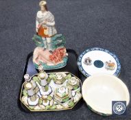 A tray of Staffordshire figure of a game hunter standing over a dead lion,