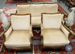 A continental carved beech three piece lounge suite, comprising of three seater settee,