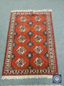 A Caucasian design rug on red ground,