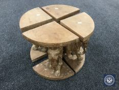 A four section occasional table on elephant supports