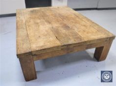 A very large hardwood coffee table made of a Mexican door,
