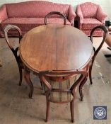 A 19th century mahogany oval dining table and four balloon back chairs