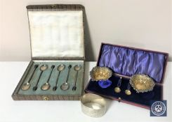 A cased pair of heart shaped silver salts with spoons,