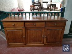 A pine sideboard fitted three drawers and cupboards