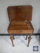A 19th century walnut sewing table