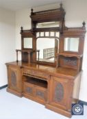 An impressive Victorian mahogany inverted breakfront mirror back sideboard with carved panel doors