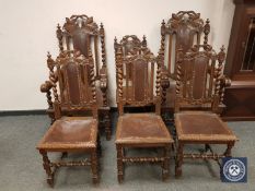 A late nineteenth century set of six heavily carved oak dining chairs,