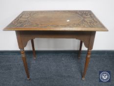A carved oak occasional table