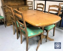 A contemporary oak dining table and six chairs