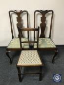 A pair of mahogany dining chairs and a single oak chair