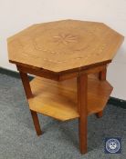 An inlaid mahogany two tier octagonal occasional table, width 57 cm.