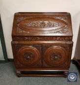 A good quality heavily carved oak fall fronted bureau, probably Lees, width 92 cm.