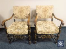 A pair of carved oak scroll armchairs in tapestry fabric