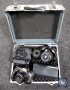 An aluminium camera case containing four Canon cameras