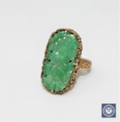 A Chinese silver gilt carved jade ring CONDITION REPORT: 7.0g. In good condition.