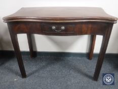 A George III shaped front mahogany foldover top tea table