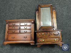 A miniature chest of drawers and a dressing table mirror