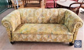 An early 20th century Chesterfield style settee in floral upholstery