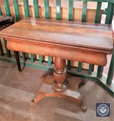 A 19th century mahogany foldover top tea table
