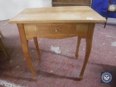 A pine side table fitted a drawer