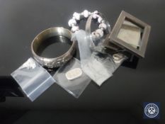 Two silver bangles, a Pandora style bracelet stamped 925, a small silver photo frames,