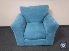 An armchair in turquoise upholstery