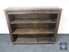 A carved oak open bookcase