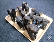 A tray of carved wooden elephant ornaments,