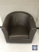 A brown leather tub chair