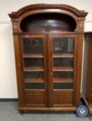 A continental carved mahogany glazed bookcase, width 113 cm.