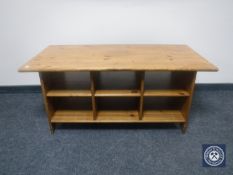 A pine coffee table fitted shelves beneath
