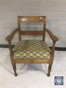 An early 20th century tapestry seated continental oak armchair