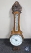 A carved oak aneroid barometer (glass cracked)