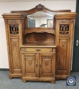 A carved oak sunk centred break-fronted mirror backed sideboard, width 167 cm.