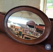 A late 19th century oval mahogany framed mirror