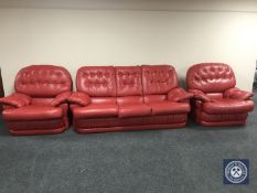 A red buttoned leather three piece lounge suite