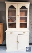 A cream painted glazed pine bookcase
